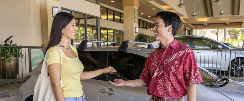 The customer is exchanging keys with the Servco Buying Center representative, showing trust in helping to sell their car fast, fair, and easy.