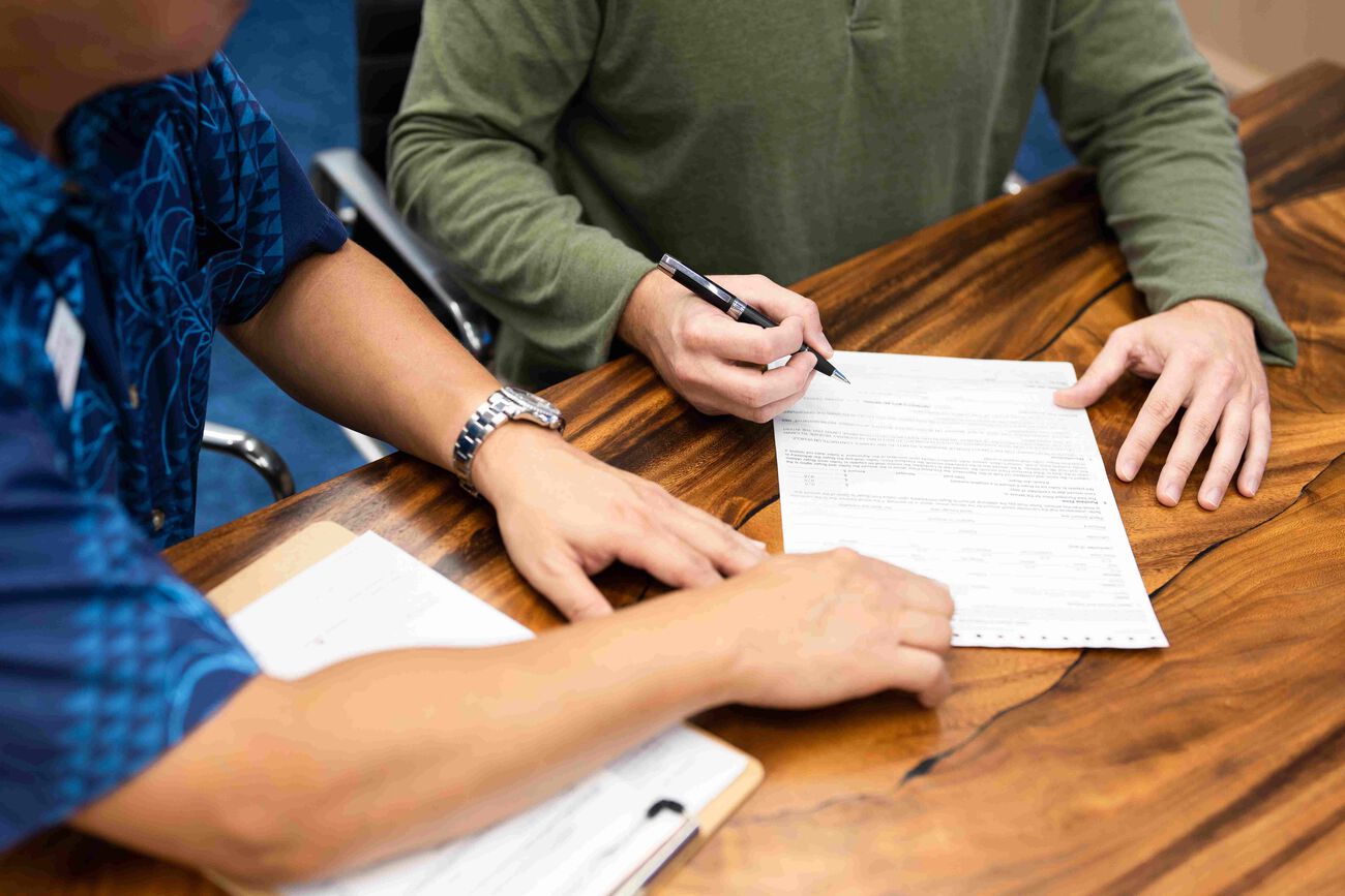 The customer and Servco Buying Center representative discussed paperwork in preparation to sell the car.